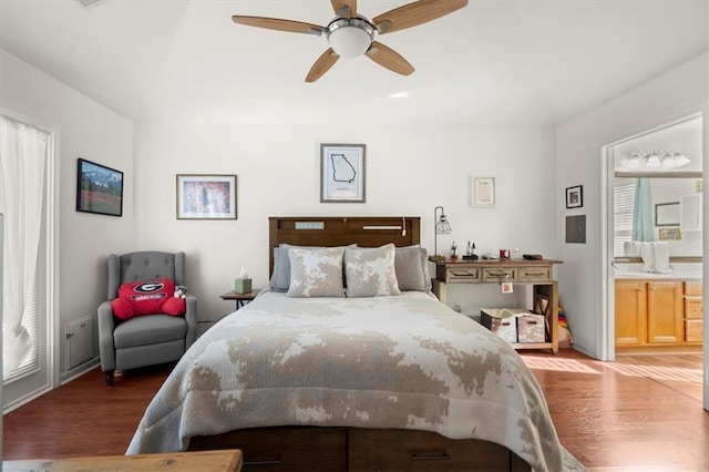 bedroom featuring ceiling fan, dark hardwood / wood-style flooring, and ensuite bathroom