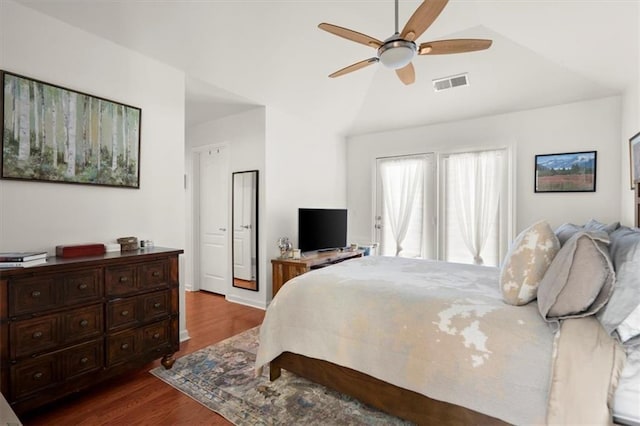 bedroom with ceiling fan, dark wood-type flooring, and vaulted ceiling