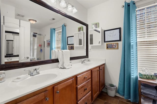 bathroom featuring tile patterned flooring, vanity, and walk in shower