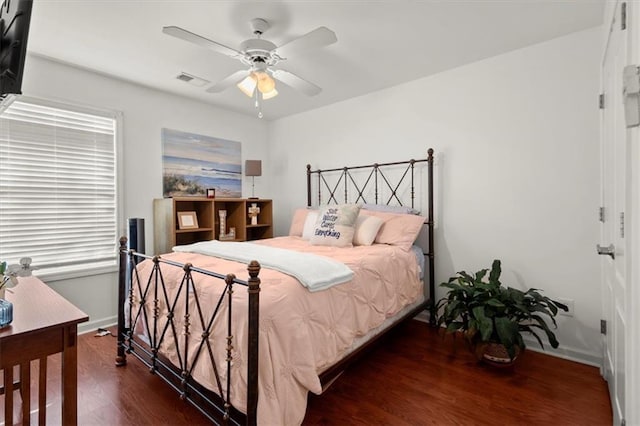 bedroom with ceiling fan and dark hardwood / wood-style flooring