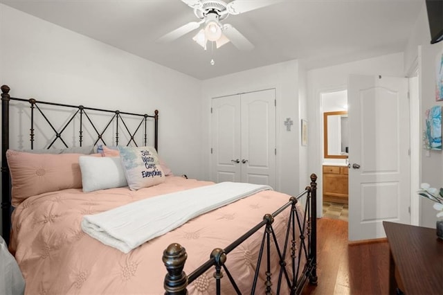 bedroom featuring hardwood / wood-style floors, ceiling fan, ensuite bath, and a closet