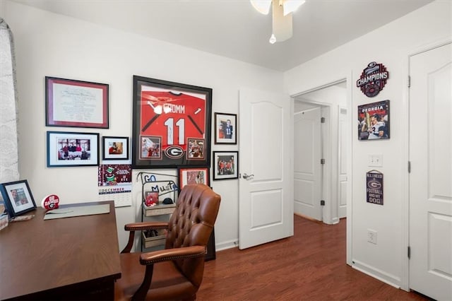 home office featuring dark hardwood / wood-style flooring and ceiling fan