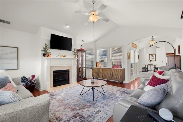 living room with hardwood / wood-style flooring, ceiling fan, and lofted ceiling