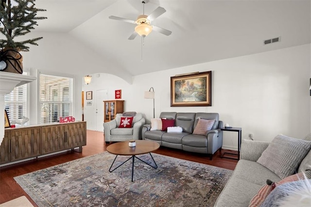 living room with ceiling fan, dark wood-type flooring, and lofted ceiling