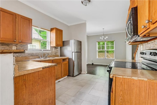 2005 Chicago Ave NW, Atlanta, GA 30314 - kitchen with stainless steel appliances, decorative backsplash, brown cabinets, decorative light fixtures, and ornamental molding