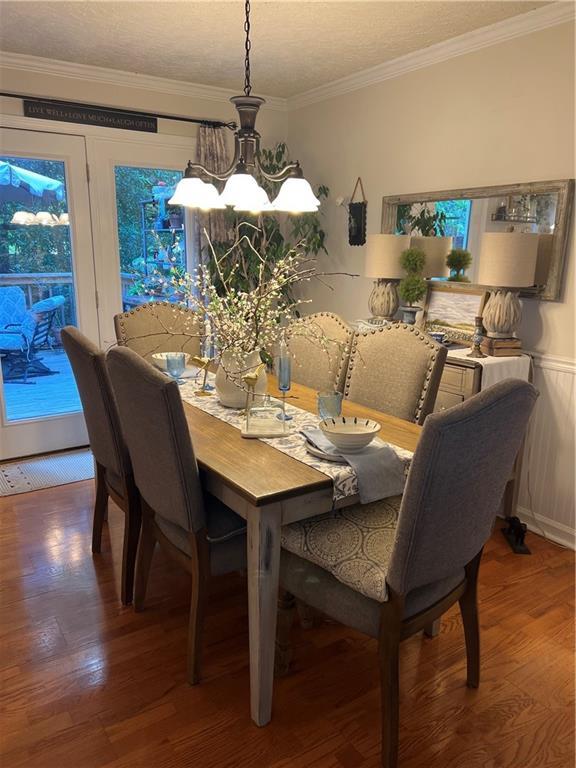 227 Bennett Farms Trl, Acworth, GA 30102 - dining space with wood finished floors, a chandelier, and ornamental molding
