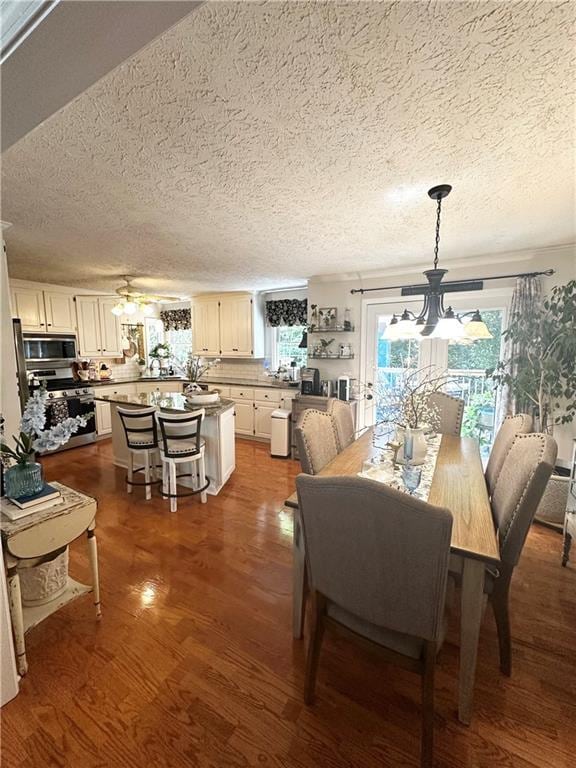 227 Bennett Farms Trl, Acworth, GA 30102 - dining room with a chandelier, a textured ceiling, and wood finished floors