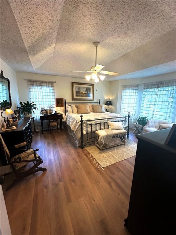 227 Bennett Farms Trl, Acworth, GA 30102 - bedroom with a textured ceiling, wood finished floors, and ceiling fan