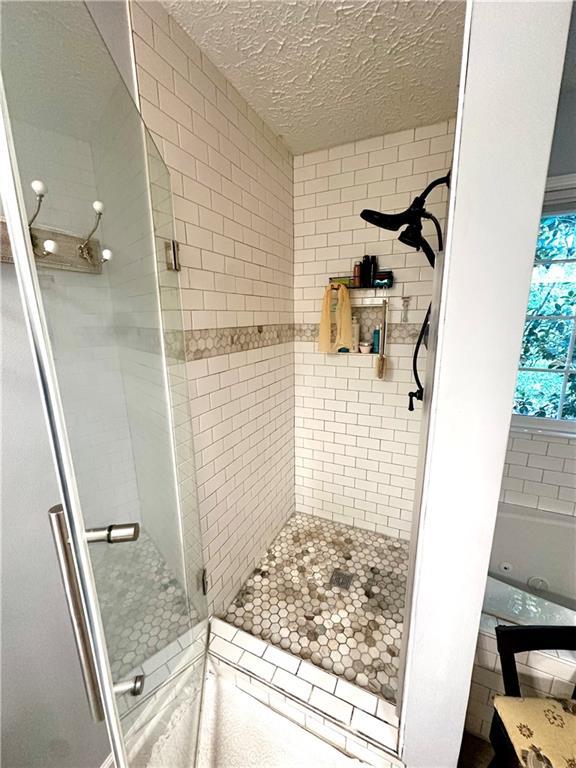 227 Bennett Farms Trl, Acworth, GA 30102 - full bath featuring a shower stall and a textured ceiling