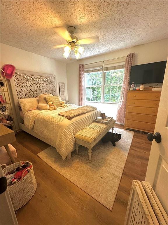 227 Bennett Farms Trl, Acworth, GA 30102 - bedroom with wood finished floors, a textured ceiling, and ceiling fan