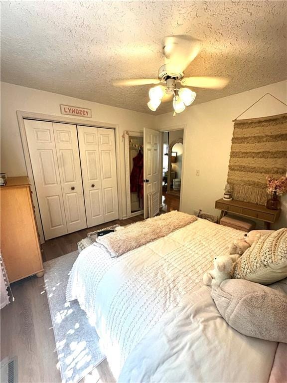 227 Bennett Farms Trl, Acworth, GA 30102 - bedroom with dark wood-type flooring, a textured ceiling, ceiling fan, and a closet