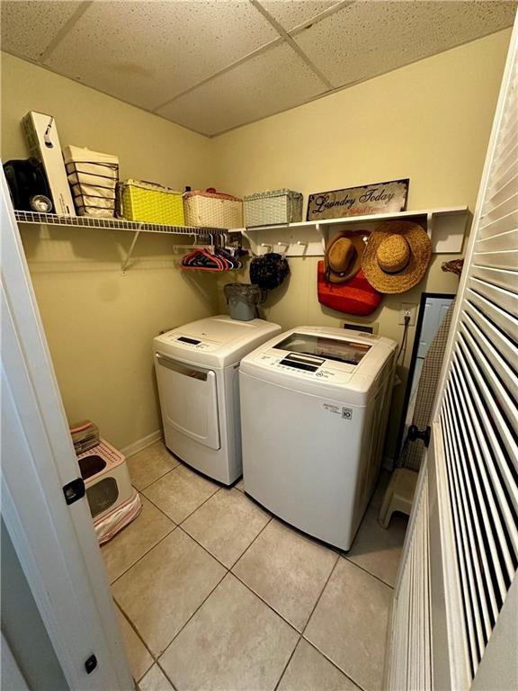 227 Bennett Farms Trl, Acworth, GA 30102 - laundry room with washer and clothes dryer and light tile patterned flooring