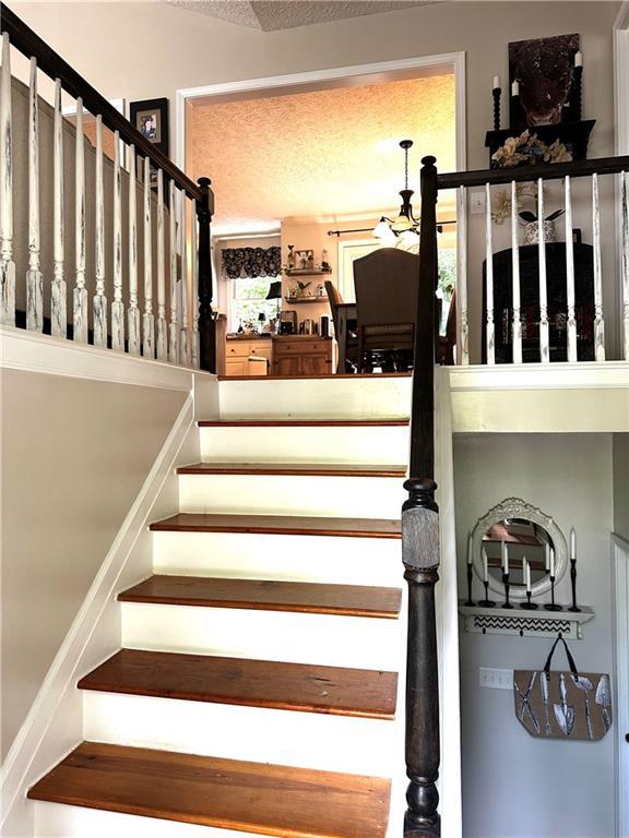 227 Bennett Farms Trl, Acworth, GA 30102 - stairs featuring a textured ceiling