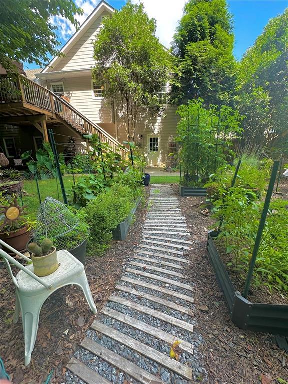 227 Bennett Farms Trl, Acworth, GA 30102 - view of yard featuring stairway, a garden, and a deck