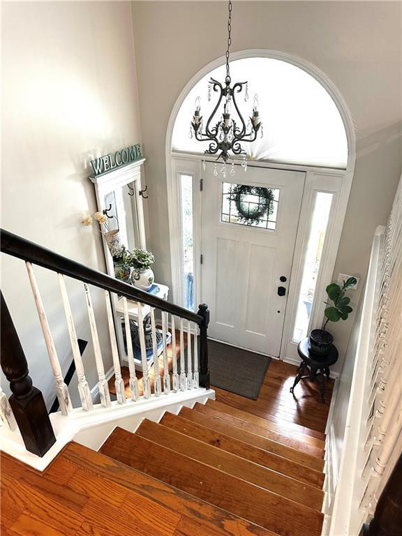 227 Bennett Farms Trl, Acworth, GA 30102 - entryway featuring stairs, a chandelier, and wood finished floors