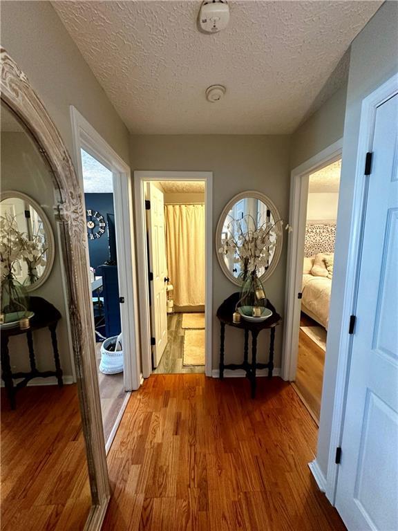 227 Bennett Farms Trl, Acworth, GA 30102 - hall featuring wood finished floors and a textured ceiling