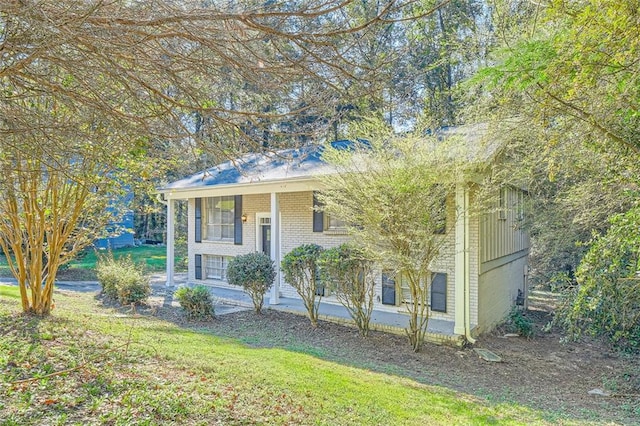 bi-level home with covered porch and a front lawn