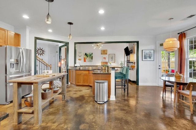 2295 Hemrick Rd, Cumming, GA 30041 - kitchen featuring stainless steel fridge with ice dispenser, concrete floors, a kitchen breakfast bar, dark countertops, and a peninsula