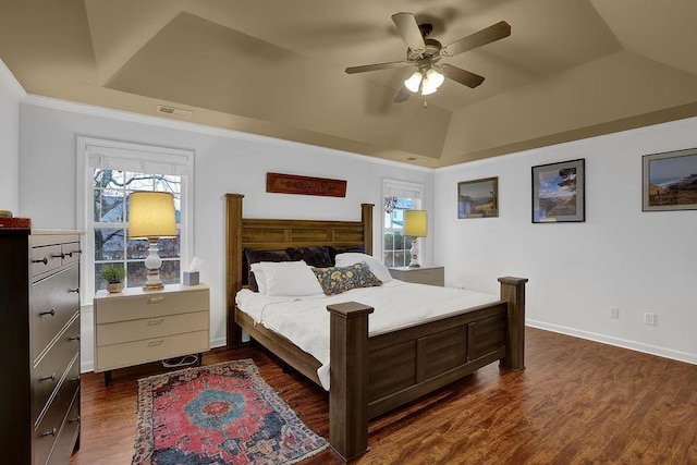 2295 Hemrick Rd, Cumming, GA 30041 - bedroom featuring multiple windows, dark wood-type flooring, vaulted ceiling, ceiling fan, and a tray ceiling