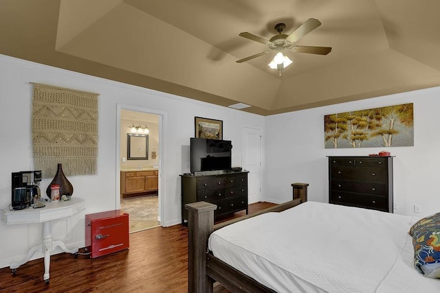 2295 Hemrick Rd, Cumming, GA 30041 - bedroom featuring dark wood-style floors, a tray ceiling, ensuite bath, and ceiling fan