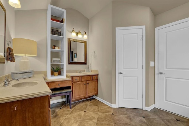 2295 Hemrick Rd, Cumming, GA 30041 - full bath with double vanity, tile patterned floors, baseboards, and lofted ceiling