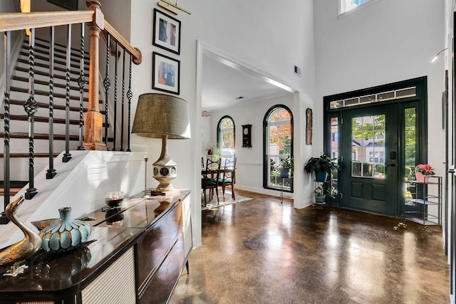 2295 Hemrick Rd, Cumming, GA 30041 - foyer with a high ceiling, stairs, finished concrete floors, and baseboards