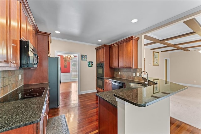 871 Windsor Creek Dr, Grayson, GA 30017 - kitchen featuring black appliances, a peninsula, dark wood-type flooring, ornamental molding, and recessed lighting