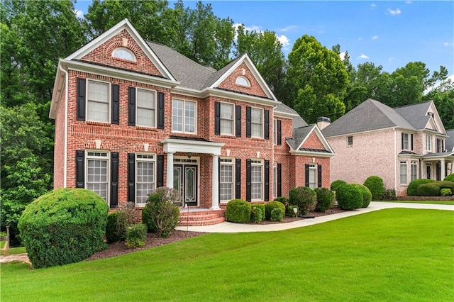 871 Windsor Creek Dr, Grayson, GA 30017 - colonial-style house with brick siding and a front yard