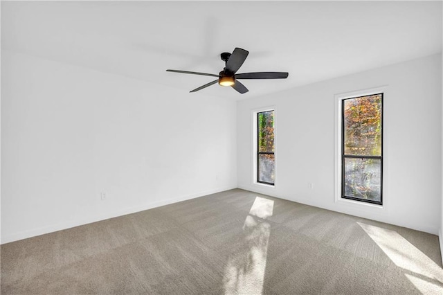 empty room featuring carpet floors and ceiling fan