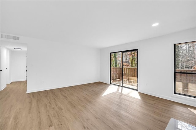 unfurnished room with light hardwood / wood-style floors