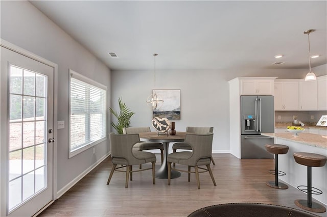 dining room with a chandelier and dark hardwood / wood-style floors