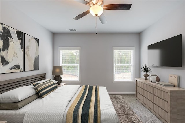 bedroom featuring light carpet and ceiling fan