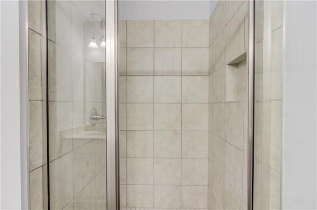 bathroom with a shower with door