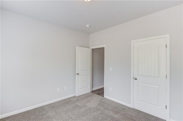 unfurnished bedroom featuring light colored carpet