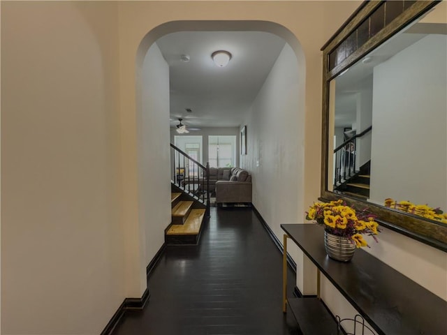 3318 Sardis Bend Dr, Buford, GA 30519 - hallway featuring arched walkways, stairway, wood finished floors, and baseboards