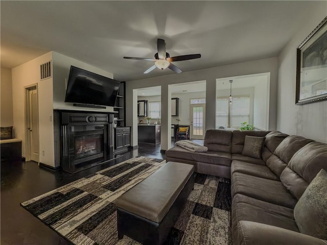 3318 Sardis Bend Dr, Buford, GA 30519 - living room with a glass covered fireplace, ceiling fan, dark wood-style floors, and baseboards