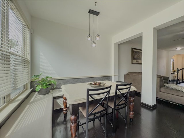 3318 Sardis Bend Dr, Buford, GA 30519 - dining area featuring arched walkways, baseboards, and dark wood-style flooring