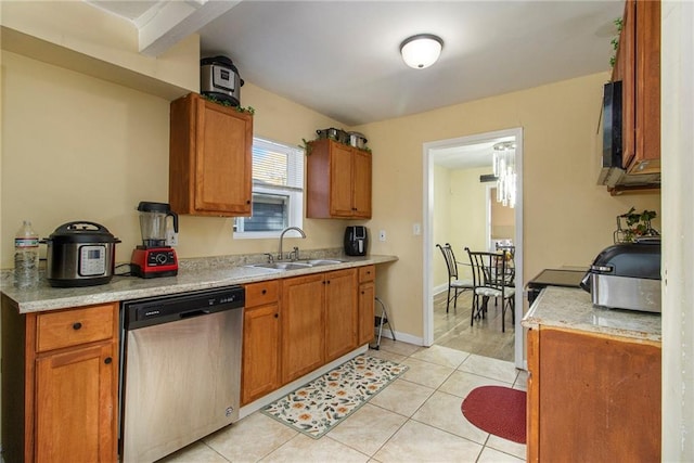 kitchen featuring stainless steel dishwasher, light tile patterned floors, and sink