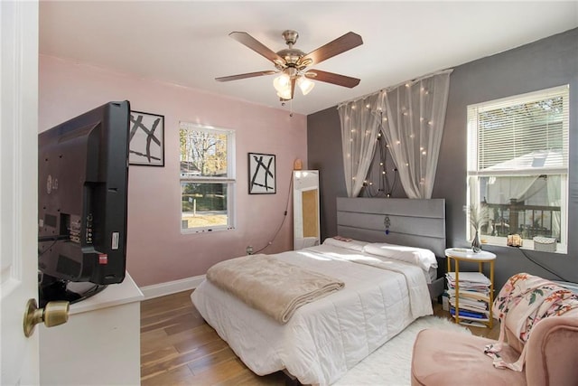 bedroom with ceiling fan and wood-type flooring