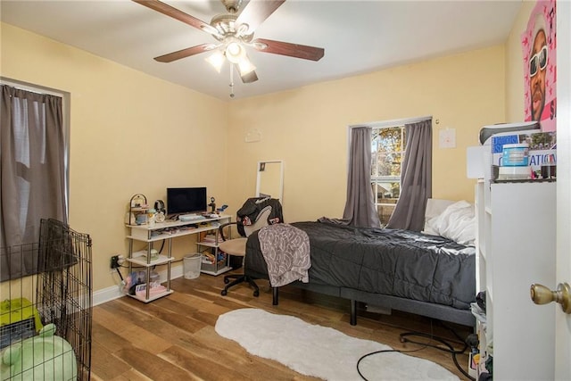 bedroom with ceiling fan and wood-type flooring