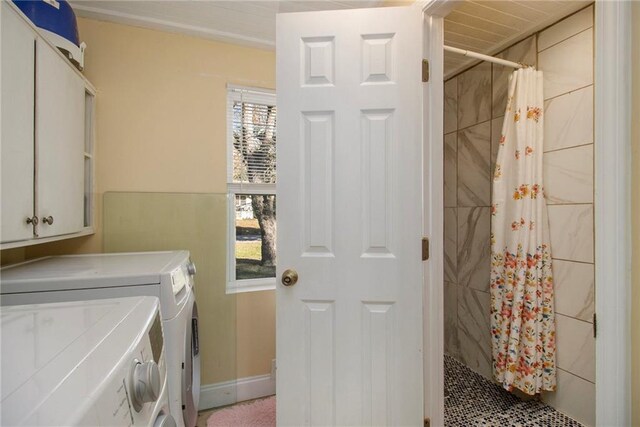 laundry room featuring plenty of natural light, cabinets, and separate washer and dryer