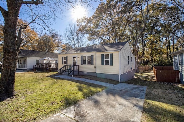 view of front of property with a wooden deck and a front yard