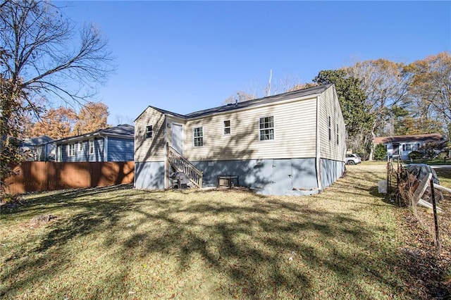 back of house with a lawn