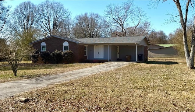 ranch-style house featuring a carport and a front lawn