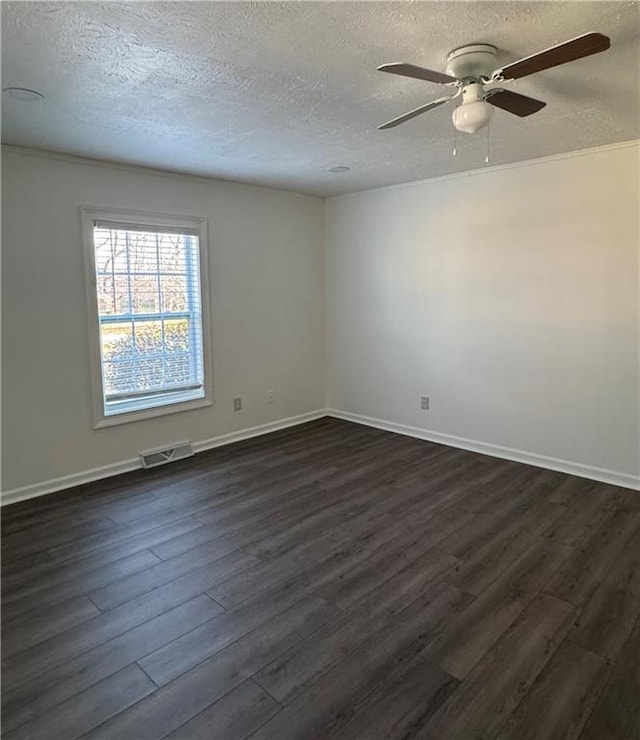 empty room with ceiling fan, dark hardwood / wood-style floors, and a textured ceiling