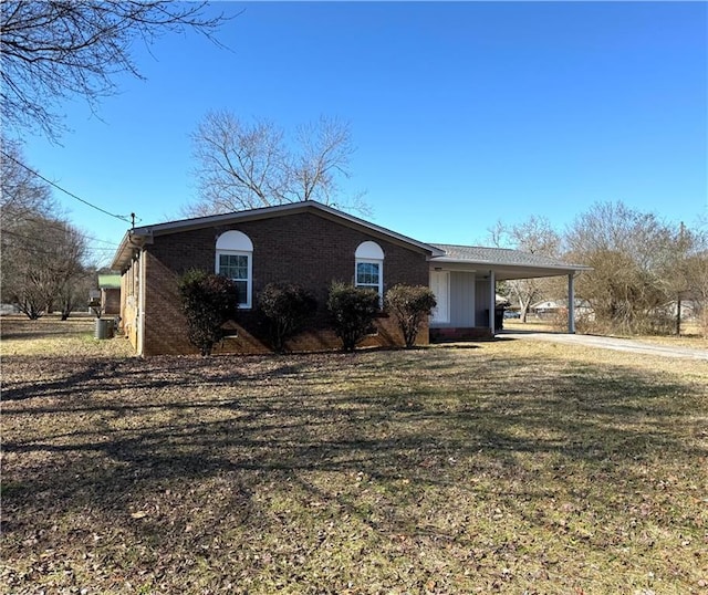 single story home featuring a carport and a front yard