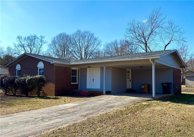 ranch-style home featuring a front yard and a carport