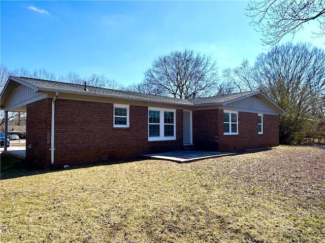 back of property with a patio and a lawn