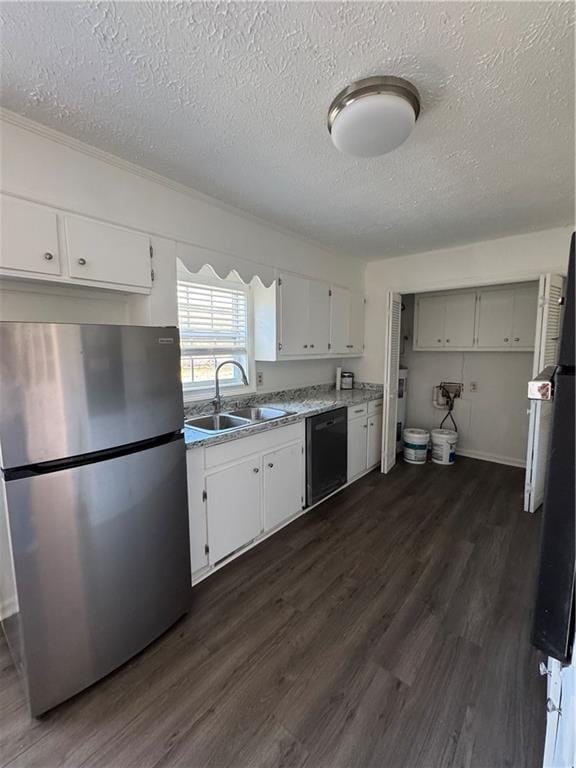 kitchen featuring sink, white cabinetry, dark hardwood / wood-style flooring, stainless steel fridge, and black dishwasher