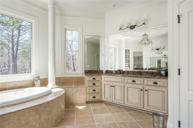 full bath featuring crown molding, decorative columns, and a healthy amount of sunlight